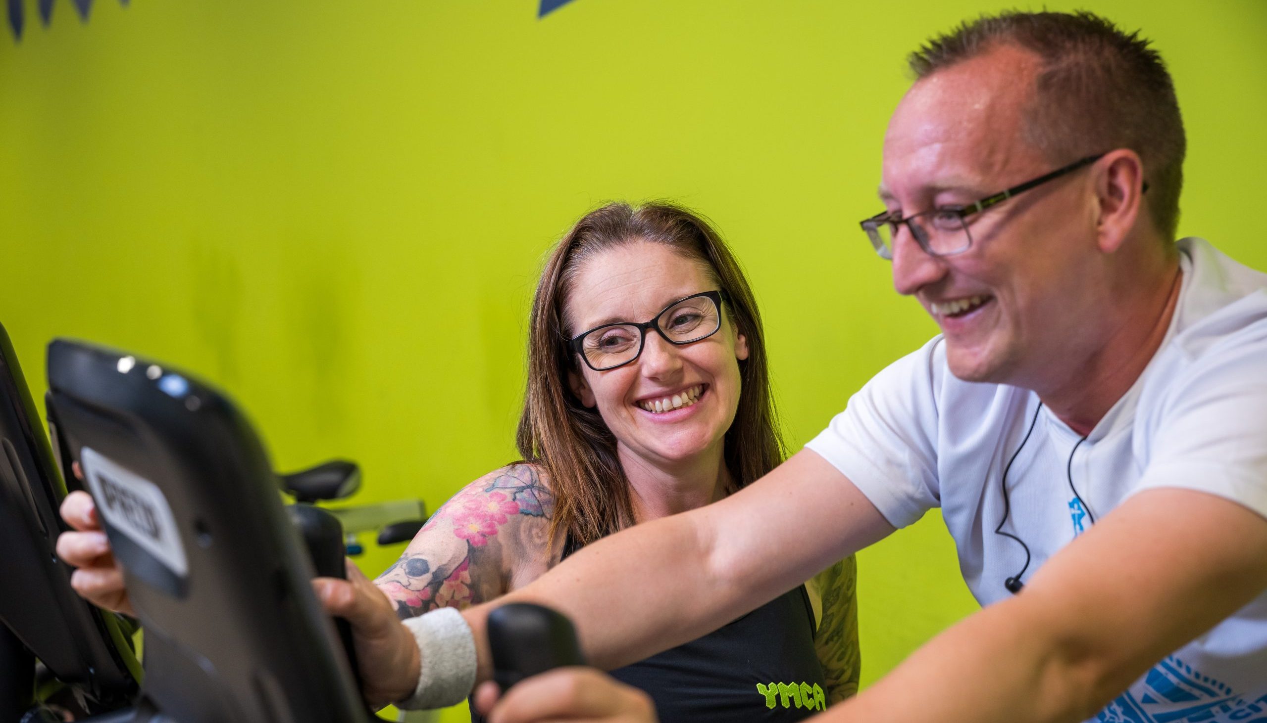 woman doing cardio workout with personal trainer at YMCA Plymouth gym